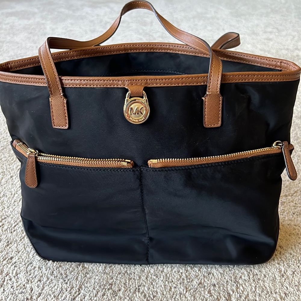 Michael Kors black bag. Includes many zipper pouches. Good for travel!
